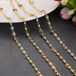 Detailed view of gold chain necklaces with colorful enamel butterflies and white pearls