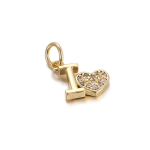 Macro detail of gold heart pendant with letter I and sparkling pavé crystals