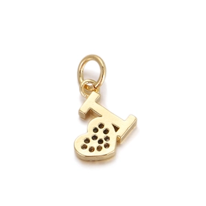 Detailed view of a gold heart-shaped charm pendant with circular hollow patterns for jewelry