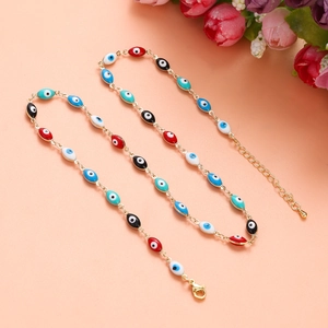 Close-up of handmade Evil Eye charm necklace with colorful enamel beads and gold chain