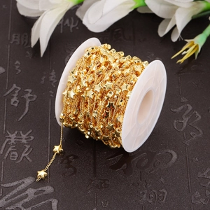 Golden stainless steel star link chain on a white spool for DIY jewelry making and crafts