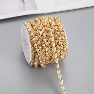 Golden pearl chain roll for DIY jewelry making and bag accessories on a white spool