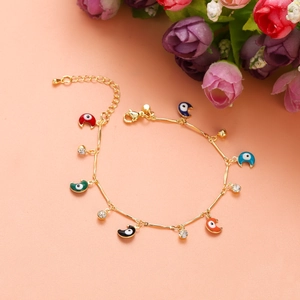 Detail of gold crescent evil eye bracelet with colorful enamel charms and crystals