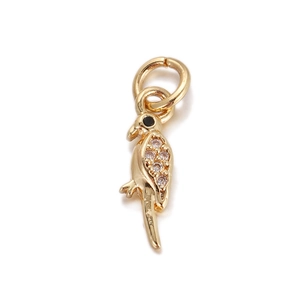 Detailed macro view of a golden parrot pendant featuring sparkling white zircon accents