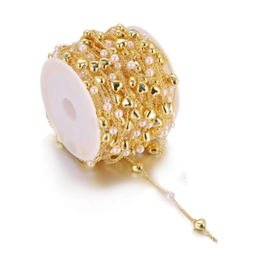 Handmade gold heart and pearl chain on a spool for DIY jewelry and hair accessories