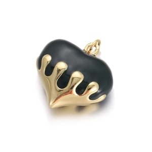 Detailed macro view of heart pendant with gold liquid texture over black enamel