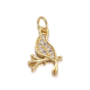 Detailed view of a gold-plated bird pendant with sparkling zircon stones and hanging loop