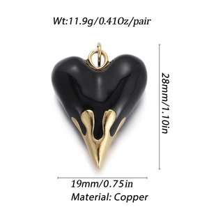 A pair of black enamel heart pendants with gold flame details made of high-quality copper