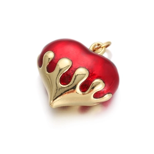 Detail of red heart pendant with melting gold finish and glossy enamel for DIY jewelry