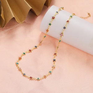Detail of gold star pendant necklace with colorful evil eye charms and extender chain