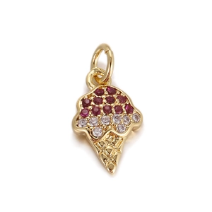Macro detail of ice cream pendant with red and white zircons in gold setting