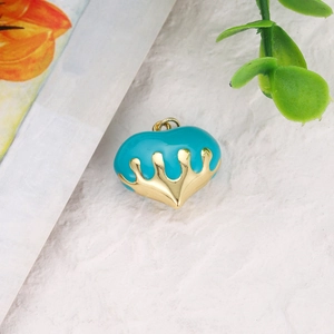 Macro shot of turquoise enamel and gold plated heart charm for DIY jewelry making