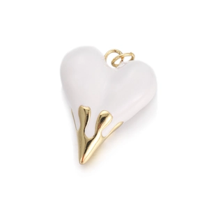 Detail of white lava heart pendant featuring gold metallic dripping texture and loop