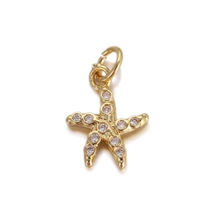 Detailed macro view of gold starfish charm pendant with sparkling cubic zirconia crystals