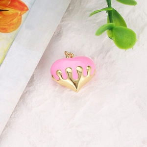 Macro shot of pink and gold heart pendant charm for DIY jewelry necklace making