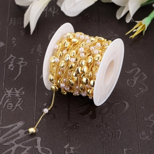 DIY jewelry chain on spool featuring gold finish, pink pearls, and heart-shaped metal beads