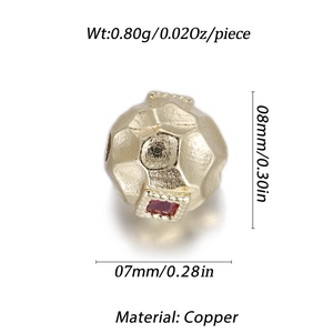 Detail of a hammered gold copper bead featuring a square red zircon stone inlay
