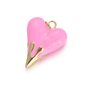 Detail of pink enamel heart pendant with gold liquid lava effect for DIY jewelry