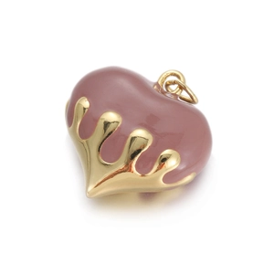 Macro detail of heart charm with purple enamel and gold plating for jewelry making