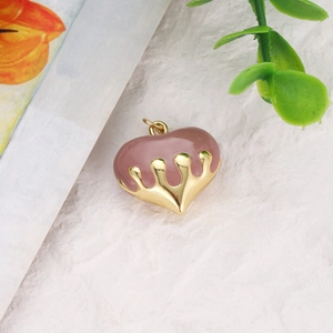 Detail of heart pendant with purple enamel and liquid gold metal finish for DIY jewelry