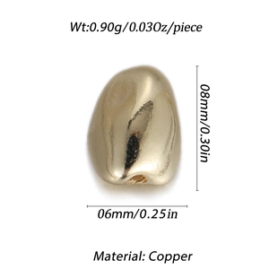 Macro shot of 8mm gold copper pebble bead with polished mirror finish for jewelry making