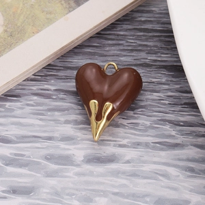 Detailed close-up of dark brown lava heart pendant with gold liquid drip effect and ring