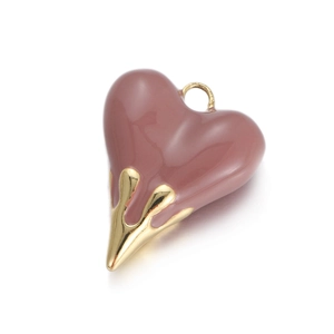 Detailed view of dark pink enamel heart pendant with melted gold metal drop effect
