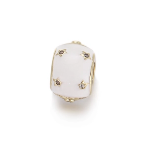 Macro view of a white enamel charm bead with gold star engravings and zircon inlay