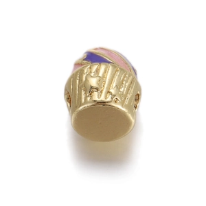 Macro detail of cupcake bead with gold finish, pink enamel and star pattern for DIY jewelry