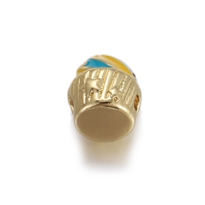 Detailed view of gold cupcake charm with blue enamel top and star carvings for DIY jewelry