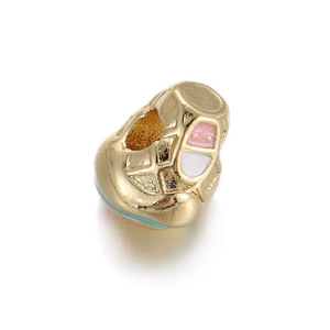 Macro detail of gold-plated enamel heart bead showing capsule design for DIY jewelry