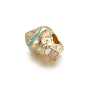 Macro view of gold-plated abstract mask beads with light blue and pink enamel for DIY jewelry