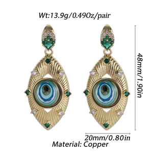 Detailed view of bohemian gold devil eye earrings with dimensions 48mm by 20mm