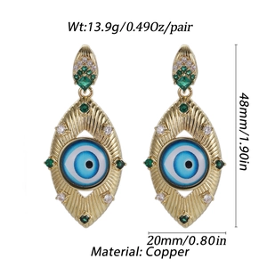 Detail view of gold-plated copper evil eye earrings with colorful zircons and weight data