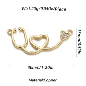 Detailed view of heart stethoscope pendant in gold-plated copper with zircon accents