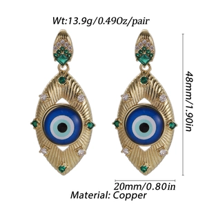 Detail view of gold-tone evil eye drop earrings with dimensions 48mm by 20mm