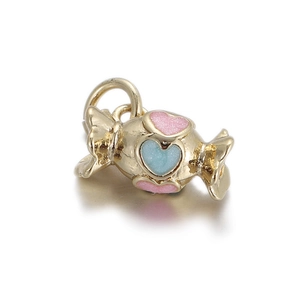 Macro detail of candy-shaped DIY jewelry pendant with glitter enamel hearts in gold