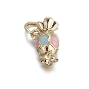 Macro shot of candy-shaped golden metal charm with pink and blue heart details for DIY jewelry