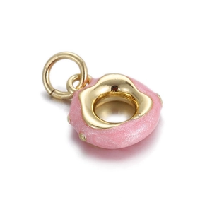 Macro shot of a pink glazed doughnut charm with gold accents and a sparkling resin finish
