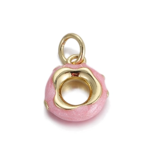 Macro view of a pink glitter enamel donut pendant with gold frosting for DIY jewelry