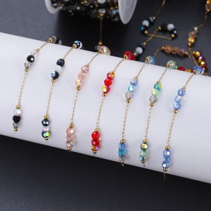 Detailed close-up of colorful faceted crystal beads with golden metal link chain