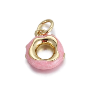 Detailed view of pink enamel donut charm with gold metal base for DIY jewelry making