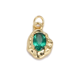 Close-up of a green oval faceted stone pendant with gold lava texture metal base