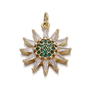 Macro shot of gold sunburst pendant featuring green and clear cubic zirconia stones