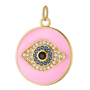 Detail of pink enamel evil eye pendant with blue zircons and gold plating
