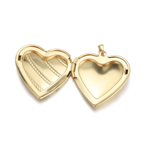 Detailed view of an open golden heart locket pendant with symmetrical interior slots