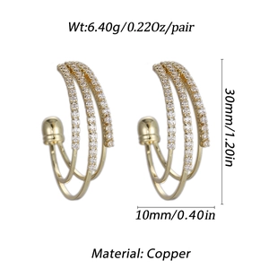 Detailed view of gold triple-layered C-shape hoop earrings with cubic zirconia inlay