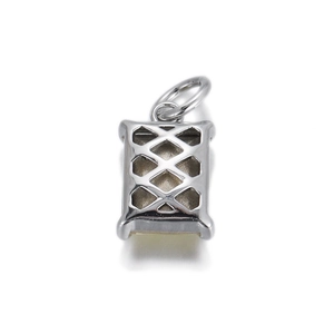 Detailed view of silver rectangular cutout pendant with geometric cross pattern DIY accessory