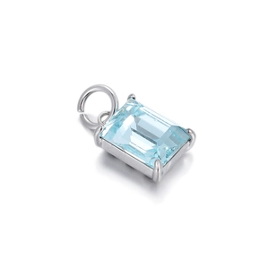 Detailed macro view of a rectangular light blue gemstone pendant in a silver four-prong setting