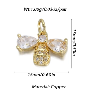 Macro detail of 14K gold plated bee pendant with clear zircons and copper material